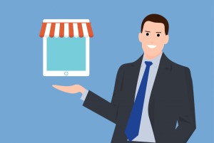 Businessman holding online shop icon